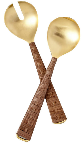 Two Be Home Ananta Brass Serving spoons, Set of 2, with large, slotted, and round heads, featuring brown, textured handles handcrafted in India, crossed over one another on a white background.