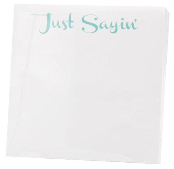 A small notepad from Black Ink, featuring the phrase "Just Sayin'" printed in turquoise at the top, elegantly placed in a modern Lucite Notepad Holder.