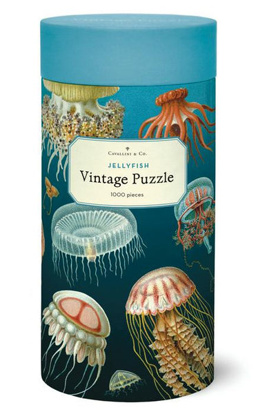 This cylindrical box contains the captivating Cavallini & Co. Jellyfish 1,000 Piece Puzzle from Cavallini Papers and Co, showcasing vibrant illustrations of enchanting jellyfish.