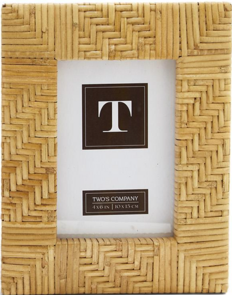 The Natural Rattan Cross Hatch Frame, designed for 4x6 inch photos, features a hand-woven rattan construction with a herringbone pattern in a natural palette. It includes a central label displaying "T" and is brought to you by the brand Two's Company, adding charm to any home décor.