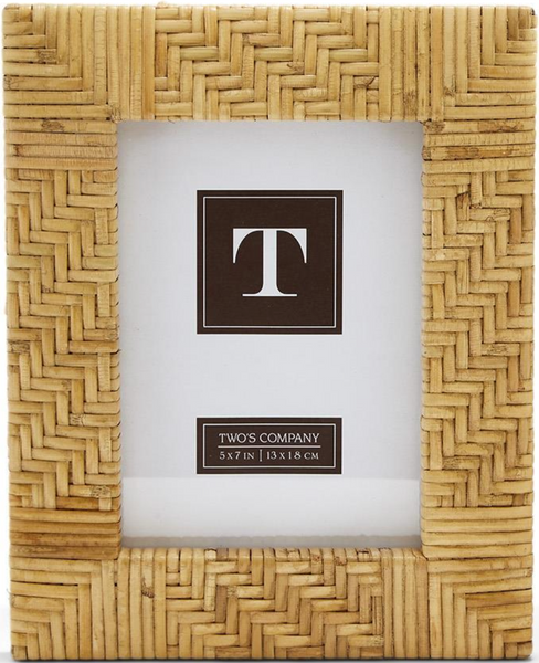 Introducing the Two's Company Natural Rattan Cross Hatch Frame, 5 x 7 inches (13x18 cm), designed with a beautiful herringbone pattern. This hand-woven rattan-style picture frame comes complete with a "T" placeholder insert, making it the perfect addition to enhance any room's décor with its elegant touch.