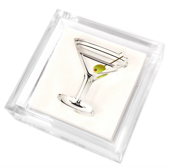 Tara Wilson Designs' Lucite Cocktail Napkin Holder with Martini Weight features a silver martini glass sculpture and green olive, elegantly displayed in a clear square case, echoing a classic martini cocktail on an immaculate white background.