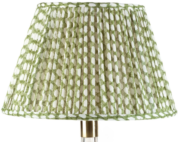 A John Rosselli Fermoie Wicker Lamp Shade in Green, featuring a green and white patterned fabric, standing on a gold-colored base.