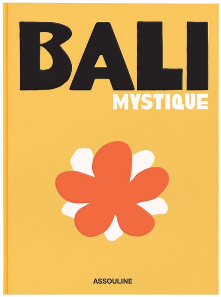 Yellow book cover titled "Bali Mystique" with an orange and white flower illustration at the bottom, capturing the essence of the Indonesian island, published by Assouline.