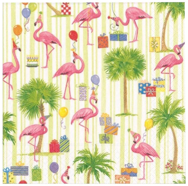 A patterned 5" x 5" Caspari Party Flamingos cocktail napkin featuring pink flamingos, palm trees, and various party supplies such as balloons, gifts, and a cake on a striped background.