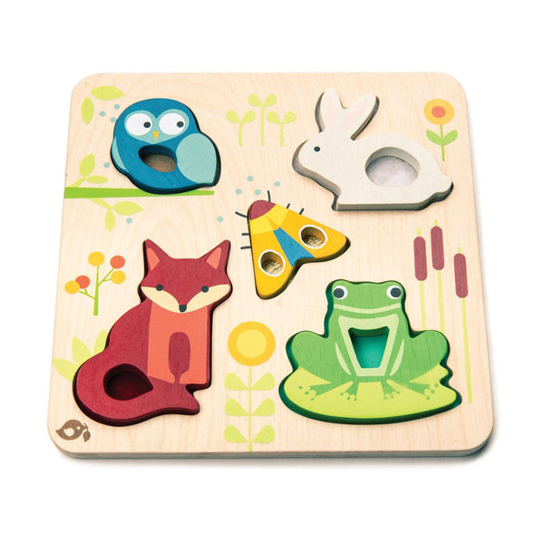 Introducing the Tenderleaf Touchy Feely Animals by Tender Leaf Toys: a delightful wooden puzzle featuring animal-shaped pieces, including an owl, rabbit, star, fox, and frog on a nature-themed board. This sensory toy promotes tactile learning and is perfect for kids who love touchy-feely animals.