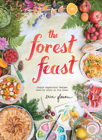 Cover image of the cookbook "The Forest Feast - Simple Vegetarian" by Abrams, featuring watercolor illustrations and surrounded by various fruits, vegetables, and prepared dishes. The title is written in a red, artistic font. This charming book highlights delicious vegetarian recipes sure to inspire your next meal.