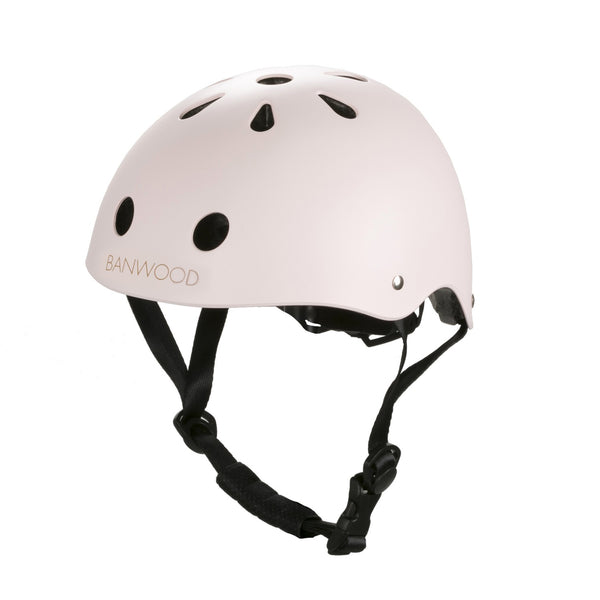 A pale pink Banwood children’s helmet with adjustable straps and a dial fit adjustment system.