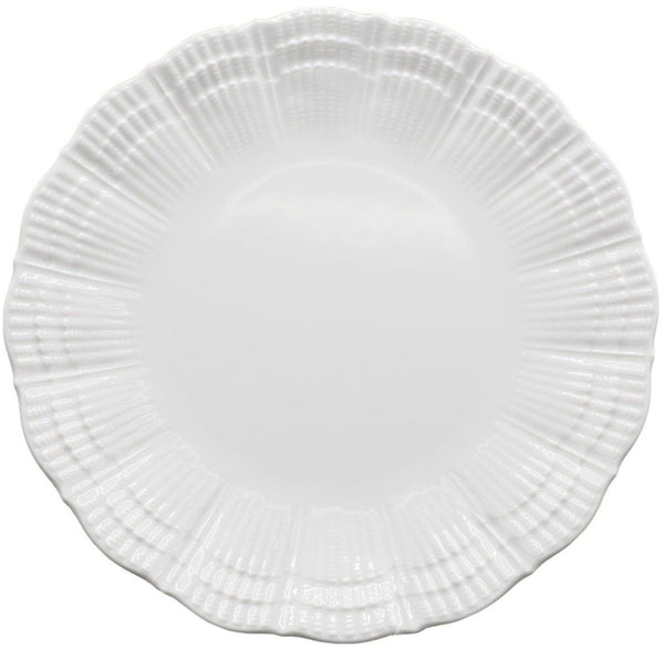 A white ceramic plate with a textured, scalloped edge is shown against a plain background, evoking the elegance of the Medard de Noblat Corail White Dinner Plate by Medard de Noblat/Devine.