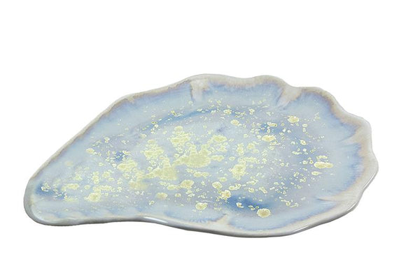 AE Ceramics platter shaped like an oyster shell with a blue glaze and speckled gold accents, isolated on a white background.