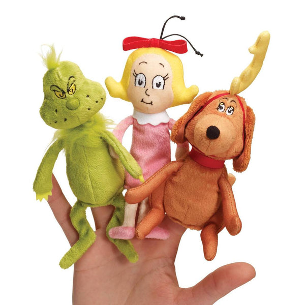 A hand holds the Dr. Seuss Grinch Finger Puppet Set by Aurora: The Grinch in green, a girl with a red bow, and a brown dog with an antler. Perfect for story-time fun!