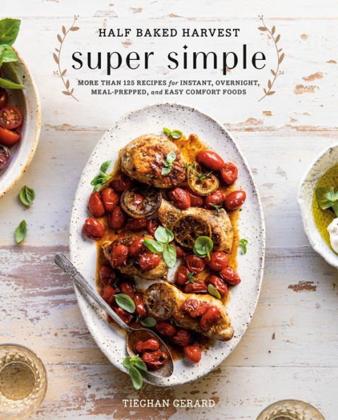 Cover of the cookbook "Half Baked Harvest Super Simple" by Penguin Random House, showcasing a dish of roasted chicken with cherry tomatoes and fresh herbs on a white plate, perfect for easy entertaining.