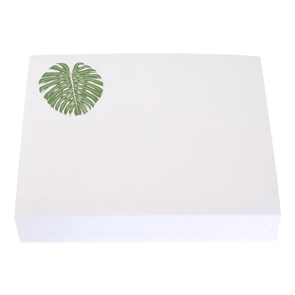 This white box features a green monstera leaf design in the upper left corner and measures 8.5" x 7". Inside, it contains a Black Ink Large Notepad with a Lucite Notepad Holder and high-quality note paper for all your writing needs.