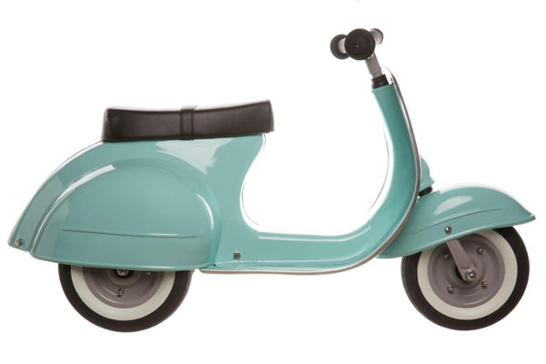 A turquoise Primo Ride On Kids Toy Classic Scooter by Amboss Toys with a black seat and white wall tires, viewed from the side, crafted from high-quality materials.