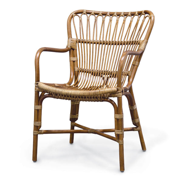 A PALECEK Retro Rattan Dining Arm Chair with armrests and a high, curved backrest featuring a woven design and a sturdy rattan frame.