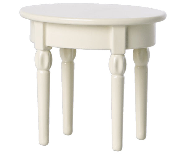 A petite, circular, white table with four intricately carved legs, perfect as a Maileg Side Table for your delightful mouse castle.