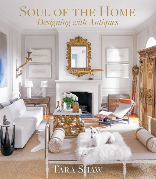 A book cover of "Soul of the Home" by Tara Shaw featuring an elegant living room brimming with French antiques, ornate furnishings, a fireplace, and a white dog. The design effortlessly merges old-world charm with contemporary interior elements. Brought to you by Common Ground.