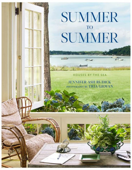 Book cover featuring a serene seaside view from a cozy porch with a wicker chair. The title "Summer to Summer" by Vendome, authored by Jennifer Ash Rudick and showcasing Tria Giovan’s photography, is displayed prominently. This book celebrates summer houses in every detail.