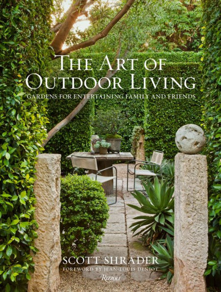 Book cover of 'The Art of Outdoor Living' by Scott Shrader, showcasing a serene garden pathway flanked by lush greenery and stone pillars, focusing on landscape design from Common Ground.