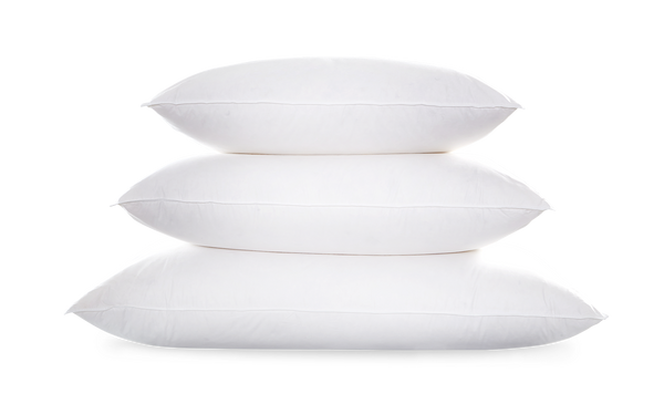 Three Matouk Valletto Goose Down Pillows, King, are stacked on top of each other against a plain background, exuding luxurious comfort.